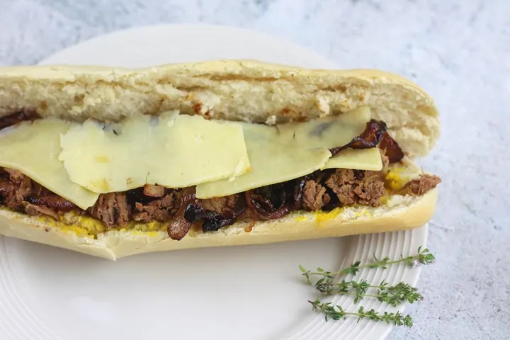 shredded beef sandwich with onions and cheese