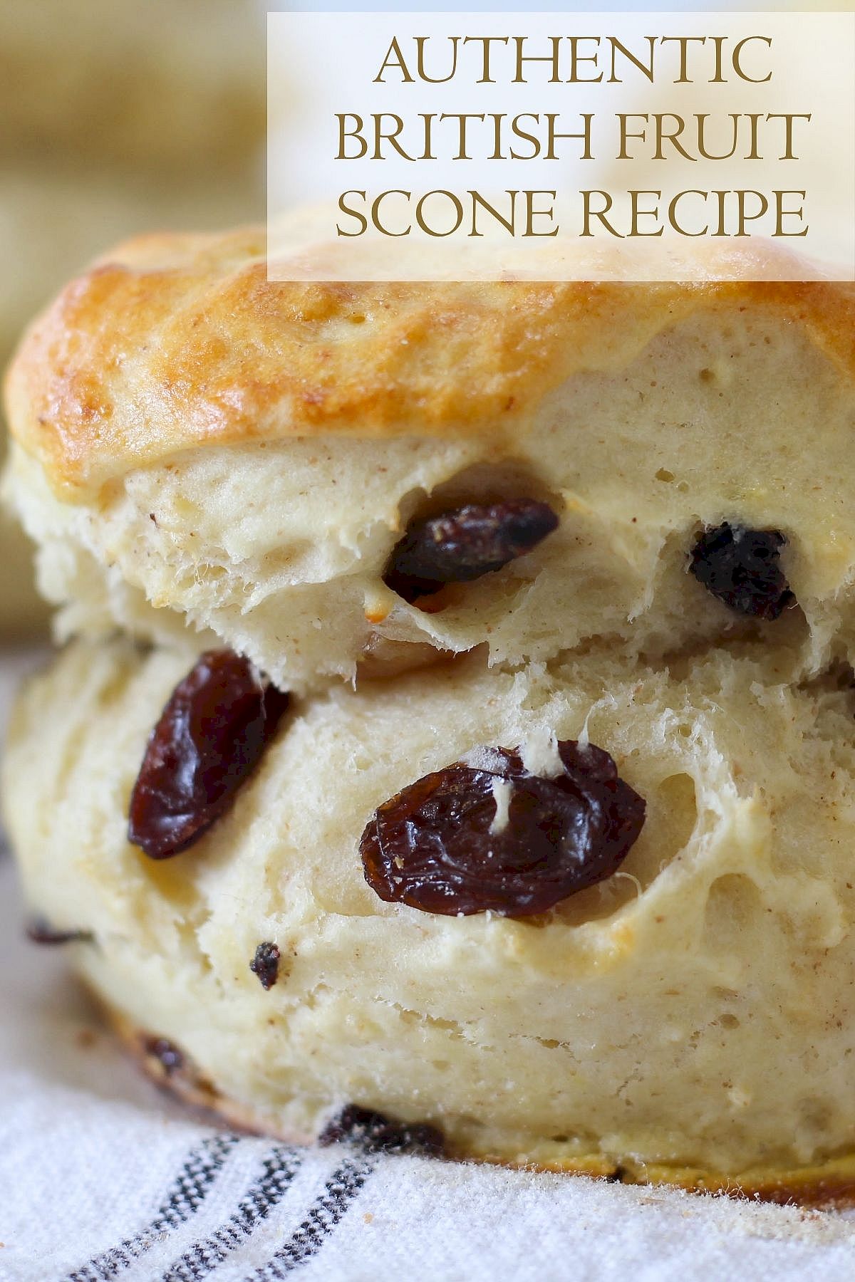 Close-up of a fresh British fruit scone with raisins, highlighting its golden texture and classic recipe.