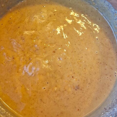 Creamy, rich pindasaus mixture in a silver bowl, ideal for baking or cooking delicious recipes. Nutty and flavorful texture.