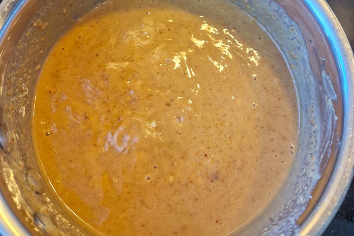 Creamy, rich pindasaus mixture in a silver bowl, ideal for baking or cooking delicious recipes. Nutty and flavorful texture.