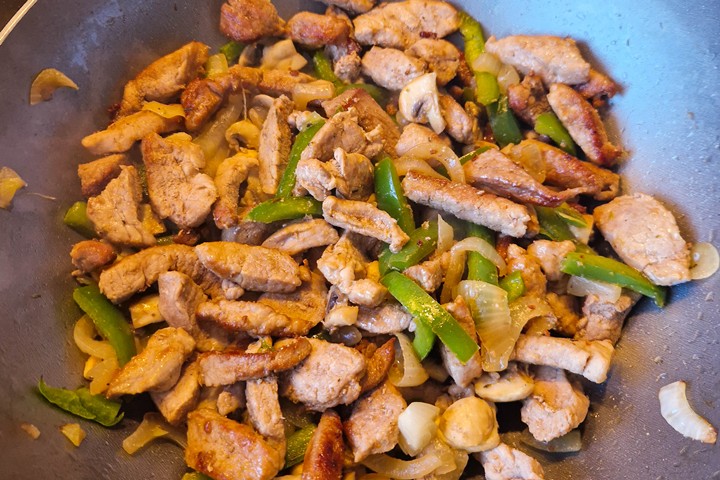 frying the pasta onions, peppers and mushrooms
